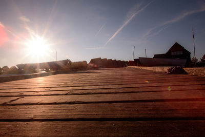 Sun shining through bridge over river