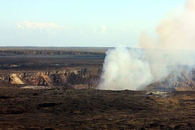 Scenic view of volcanic smoke against sky