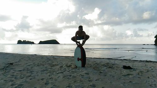 Man standing on beach against sky