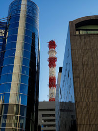 Low angle view of modern buildings against clear blue sky