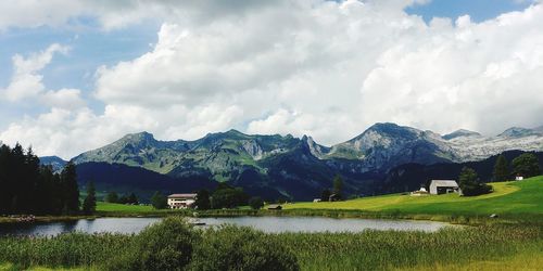 Scenic view of field and mountains against sky