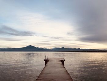 Pier over lake against sky