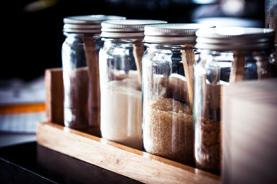 Close-up of various ingredients in glass jars at shop
