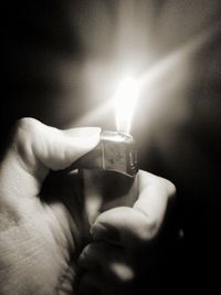 Cropped image of hand holding candle