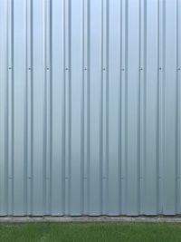 Closed metal fence against wall