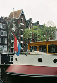 Close-up of ship in city against sky