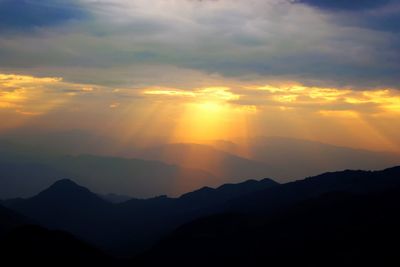 Scenic view of silhouette mountains against sky during sunset