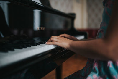 Midsection of man playing piano