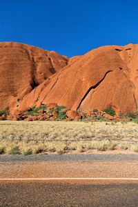 Scenic view of desert against clear blue sky