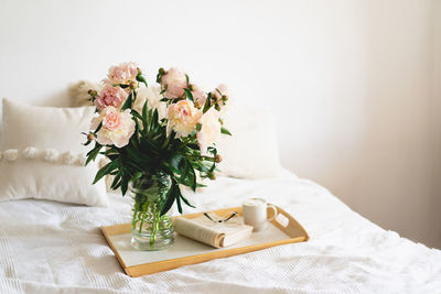 Open book and bouquet white pink peonies flowers. read and rest. cozy home