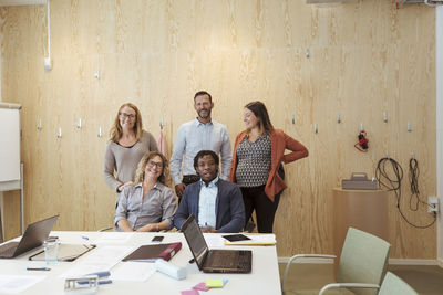 Confident business colleagues in board room at office