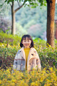 Portrait of smiling boy standing on land