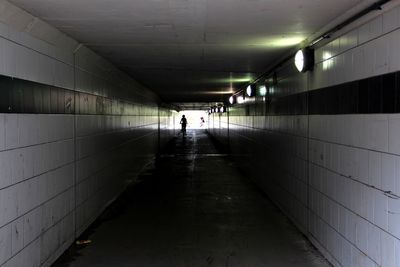 People in illuminated tunnel