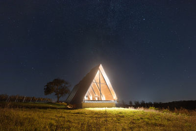 Illuminated chapel under the starry sky