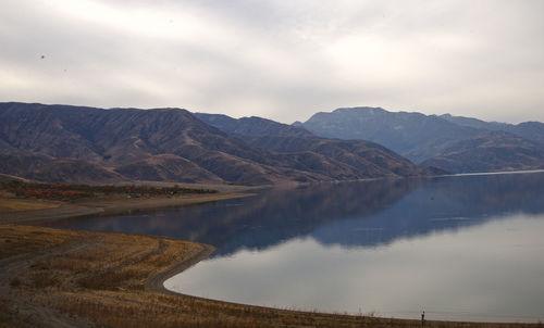 Scenic view of lake and mountains against sky