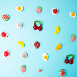 Full frame shot of multi colored candies against blue background