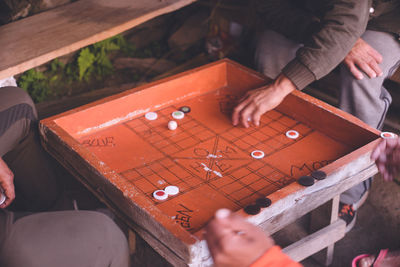 Nepal pokhara to himalayas poon hill trekking villagers playing board games in a mountain town.