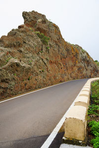 Empty road leading towards mountains