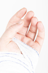 Close-up of woman hand over white background