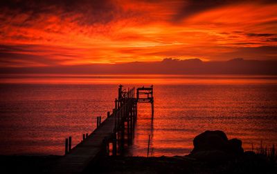 Scenic view of sea against orange sky