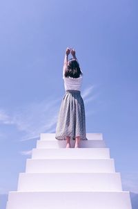 Low angle view of woman standing on staircase