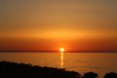 Scenic view of sea against romantic sky at sunset