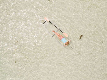 Directly above shot of woman on inflatable boat in sea