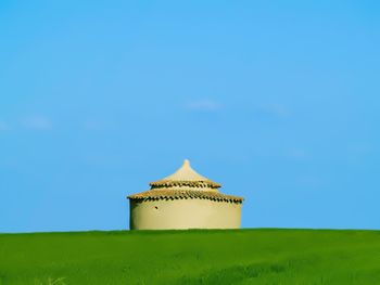 Built structure on field against clear sky