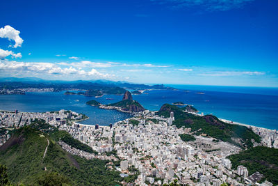 Scenic view of bay against clear blue sky