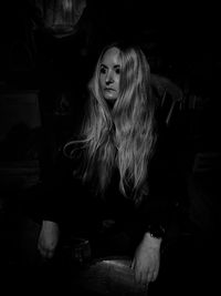 Portrait of a woman sitting in a room