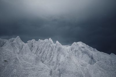 Close-up low angle view of snow against sky