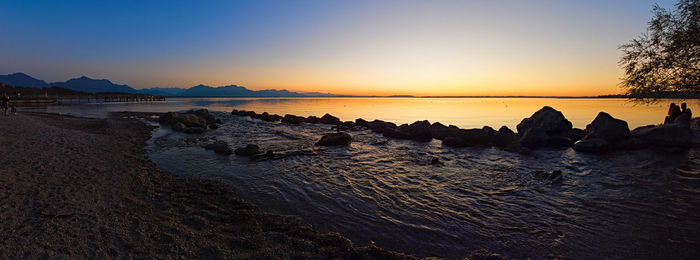 Scenic view of sea against clear sky during sunset