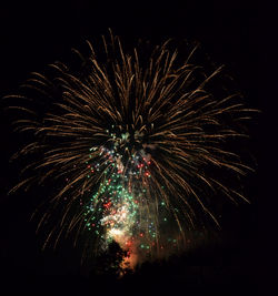 Low angle view of firework display at night