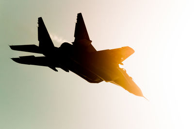 Low angle view of airplane flying against clear sky