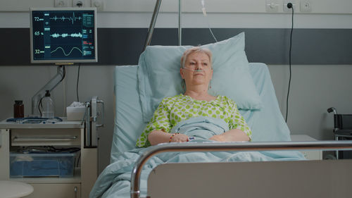 Portrait of young woman sitting in hospital