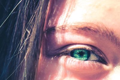 Close-up portrait of woman with green eye