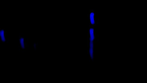 Close-up of illuminated light painting against black background