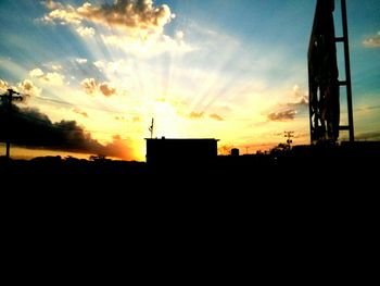 Silhouette of built structure at sunset