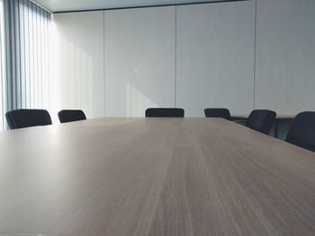 Empty office chairs by table in conference room
