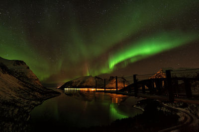 Scenic view of lake against sky at night