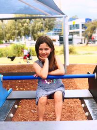 Portrait of girl sitting on playground