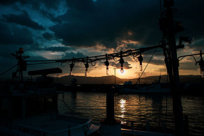 Silhouette sailboat against sky during sunset