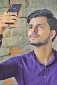 Portrait of young man using mobile phone