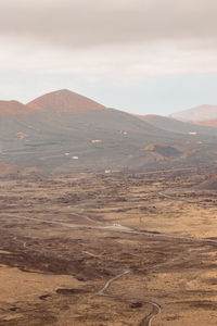 Scenic view of arid landscape against sky