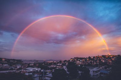 Scenic view of rainbow over city