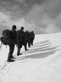 People walking on snow covered landscape