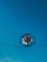 Low angle view of cables against clear blue sky