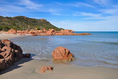 Scenic view of rocks in sea against sky