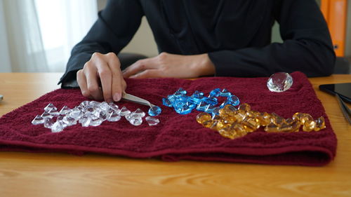 Midsection of bride and wedding rings on table