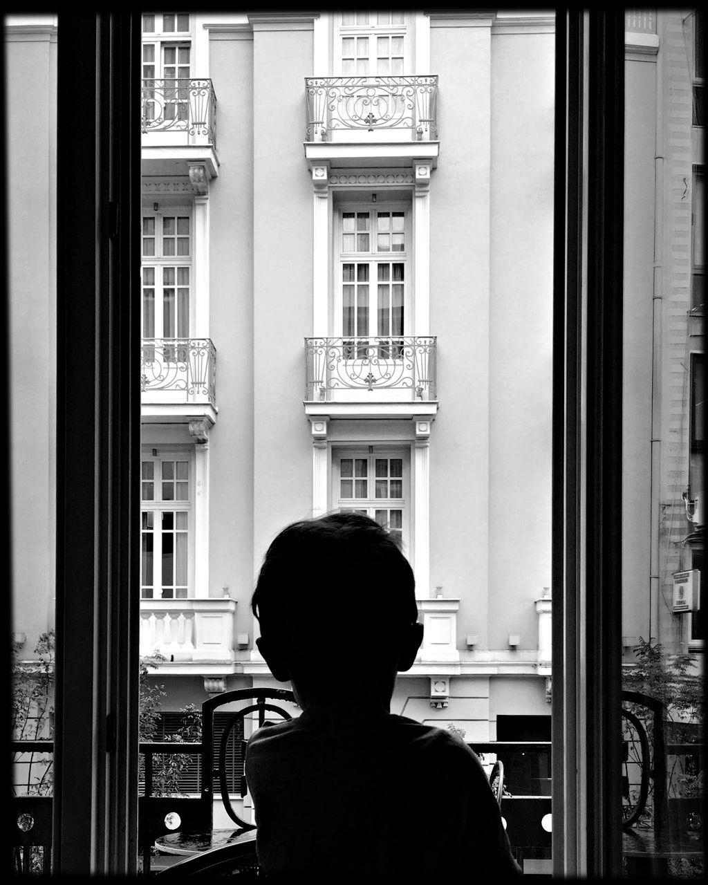 real people, one person, window, architecture, building exterior, rear view, built structure, men, leisure activity, indoors, lifestyles, looking through window, day, standing, people
